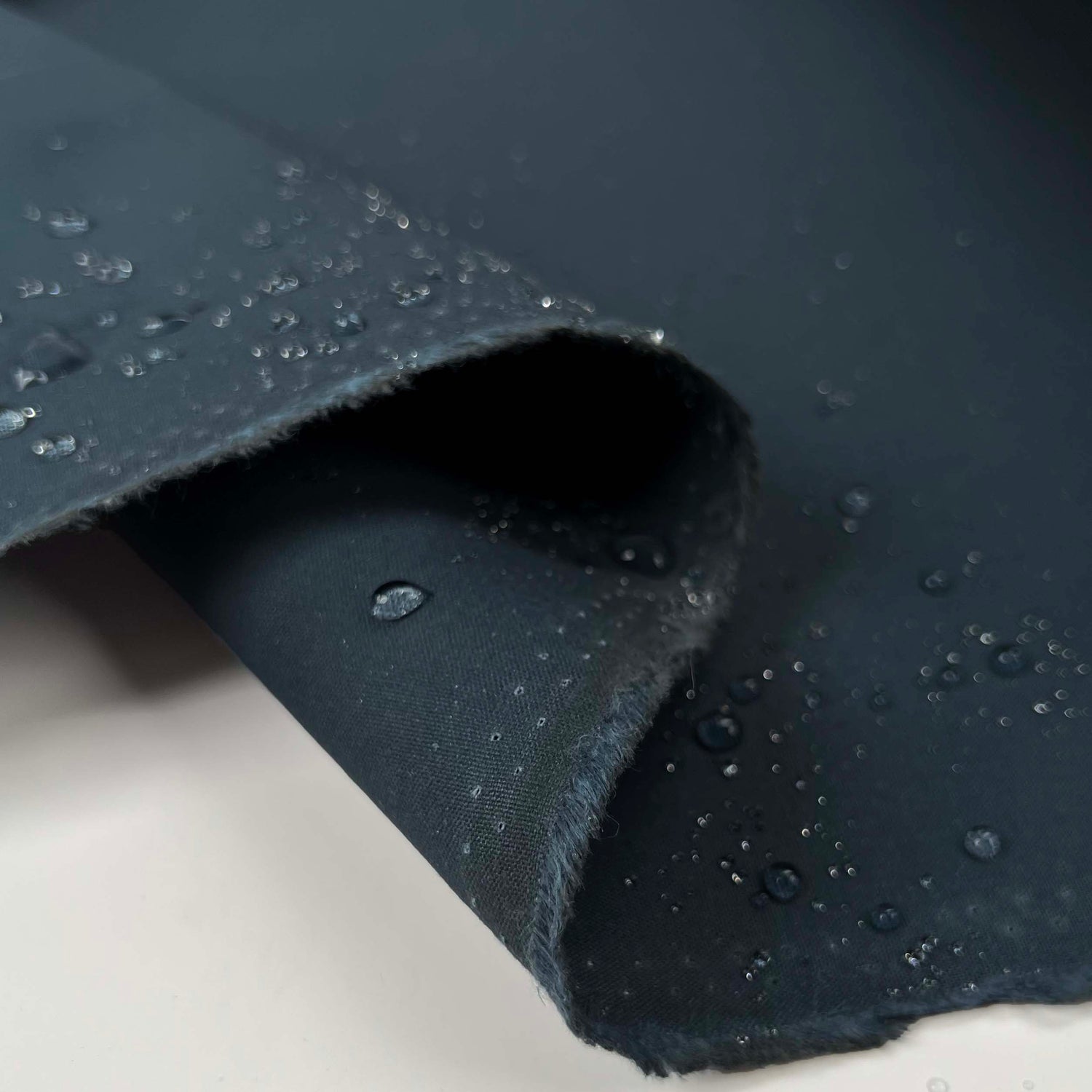 Deep Tarn Wax Cotton Teal British Millerain Coating Fabric Fold