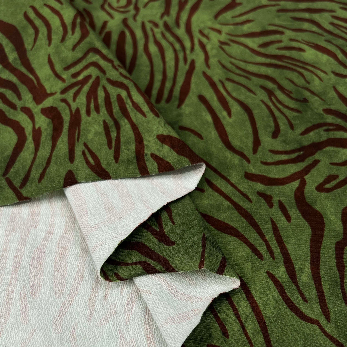 French_Terry_Grass_Roots_Green_Brown_Abstract_Print_Cotton_Elastane_Knit_Jersey_Fabric_Fold
