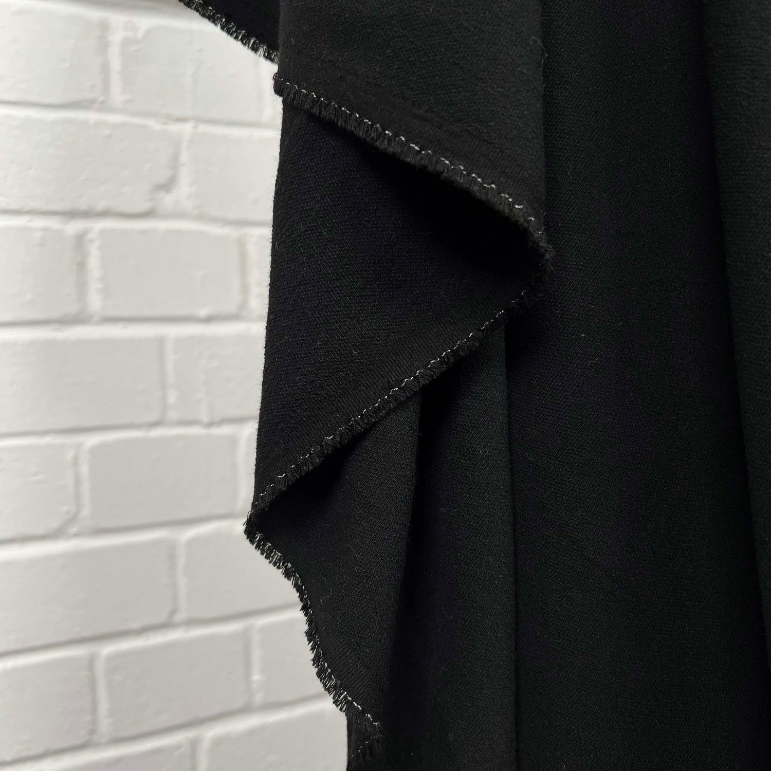 Moving Well Polyester Wool Elastane Black Midweight Portuguese Suiting Fabric Hang