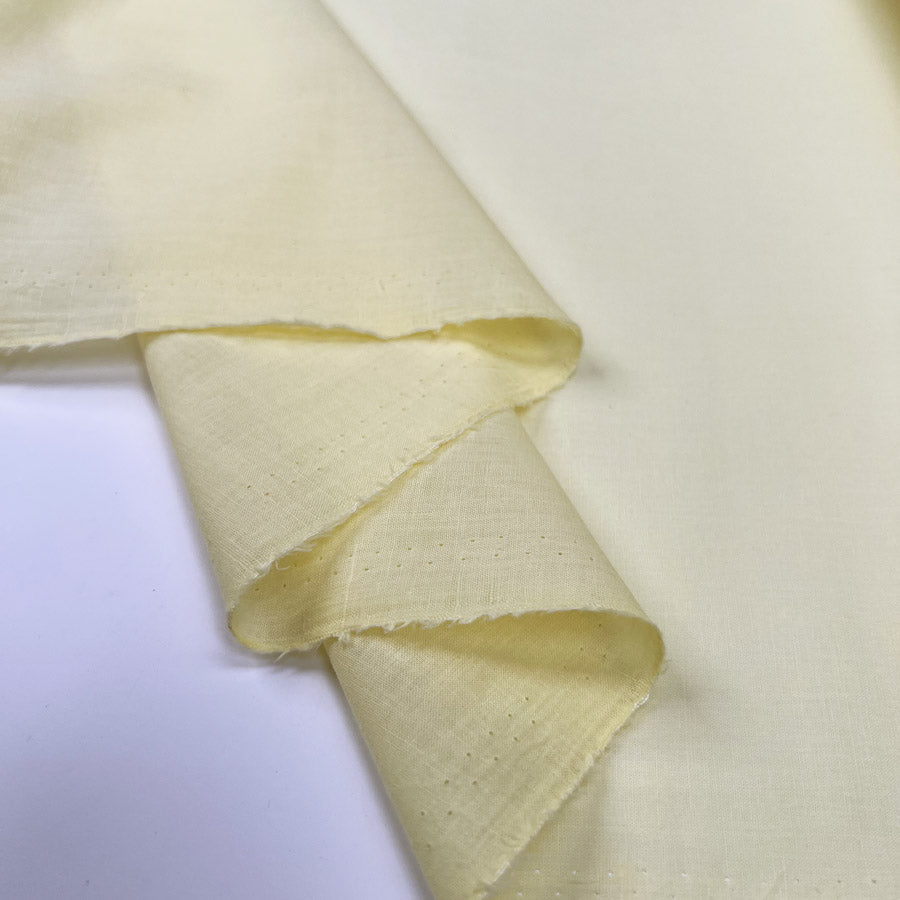 Pennine Cotton Lawn Lemon Yellow Plain Woven Fine Lightweight Dress Fabric Fold