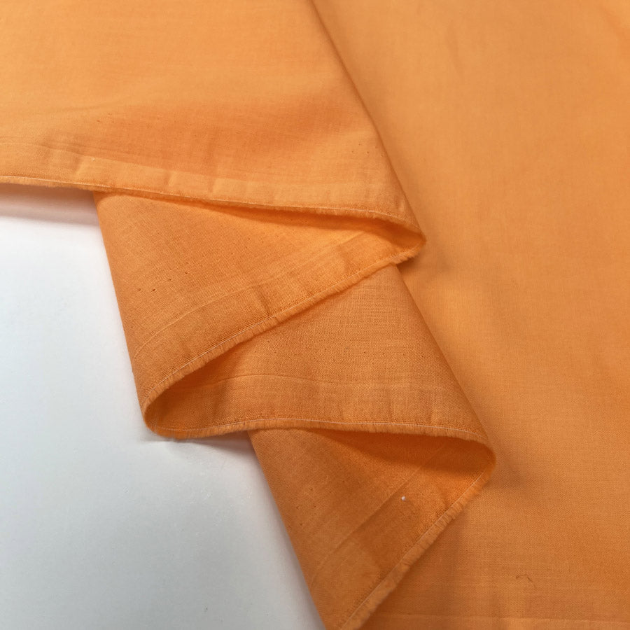 Pennine Cotton Lawn Orange Plain Woven Fine Lightweight Dress Fabric Fold