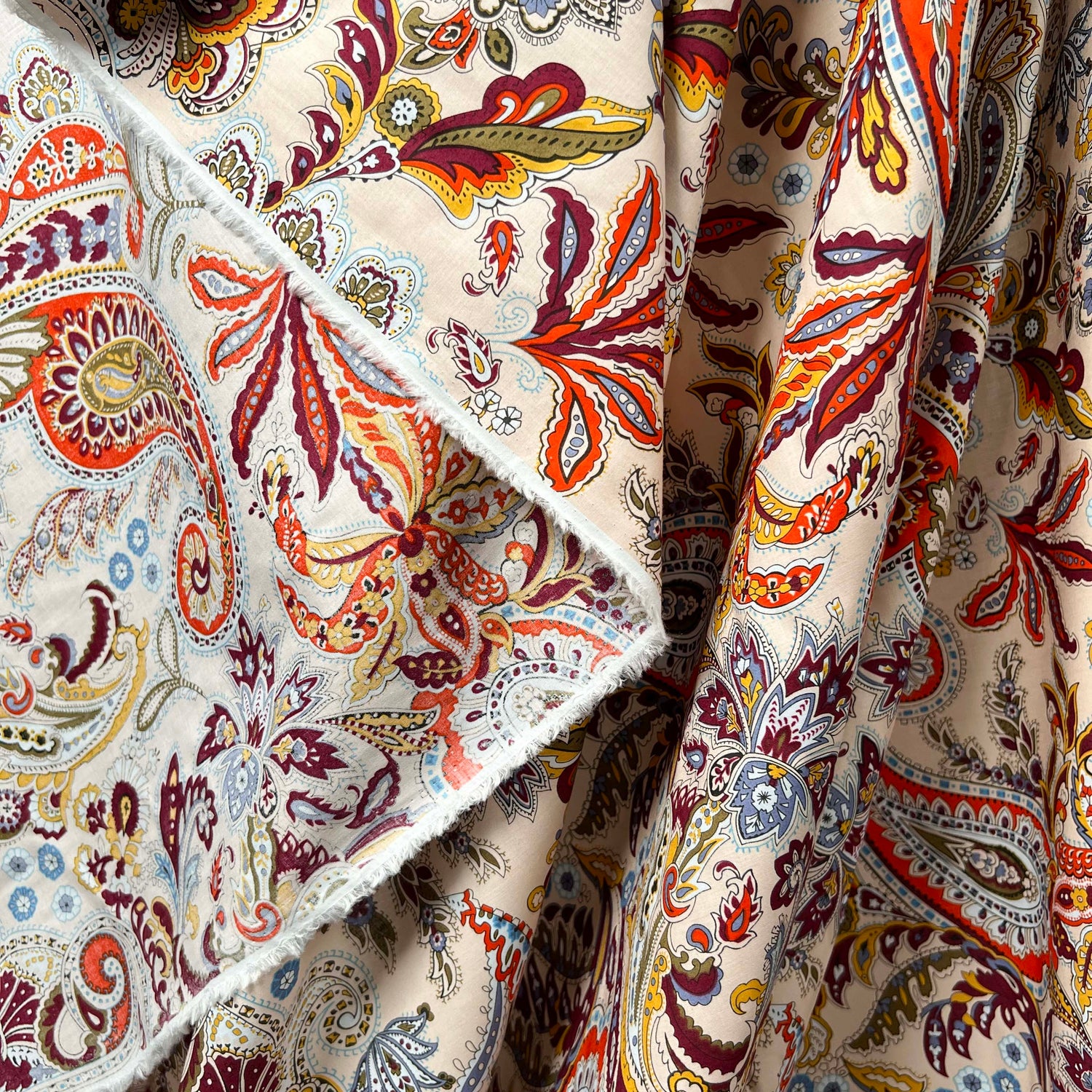 Pima Cotton Lawn Spice Market Abstract Paisley Red Dress Fabric Hang