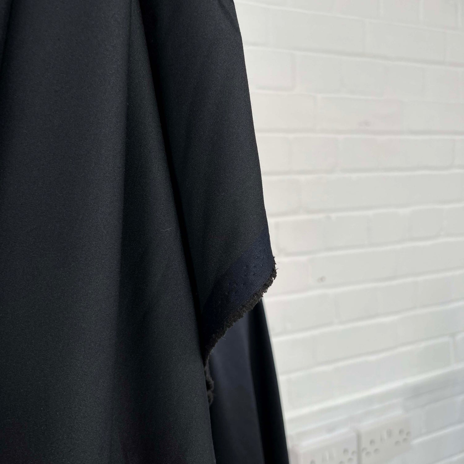 What Shines Yonder Polyester Navy Black Satin Heavy Dress Fabric Hang