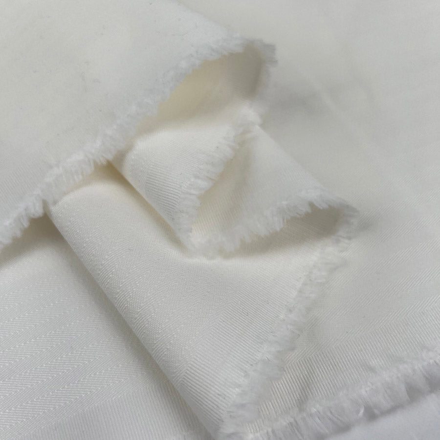 Be Mood Ivory Stretch Cotton Herringbone Trousering Fabric Fold