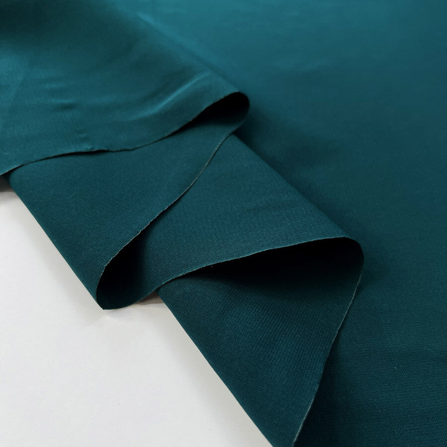 Core Range Polyester Peach Finish Teal Lightweight Woven Dress Fabric Fold