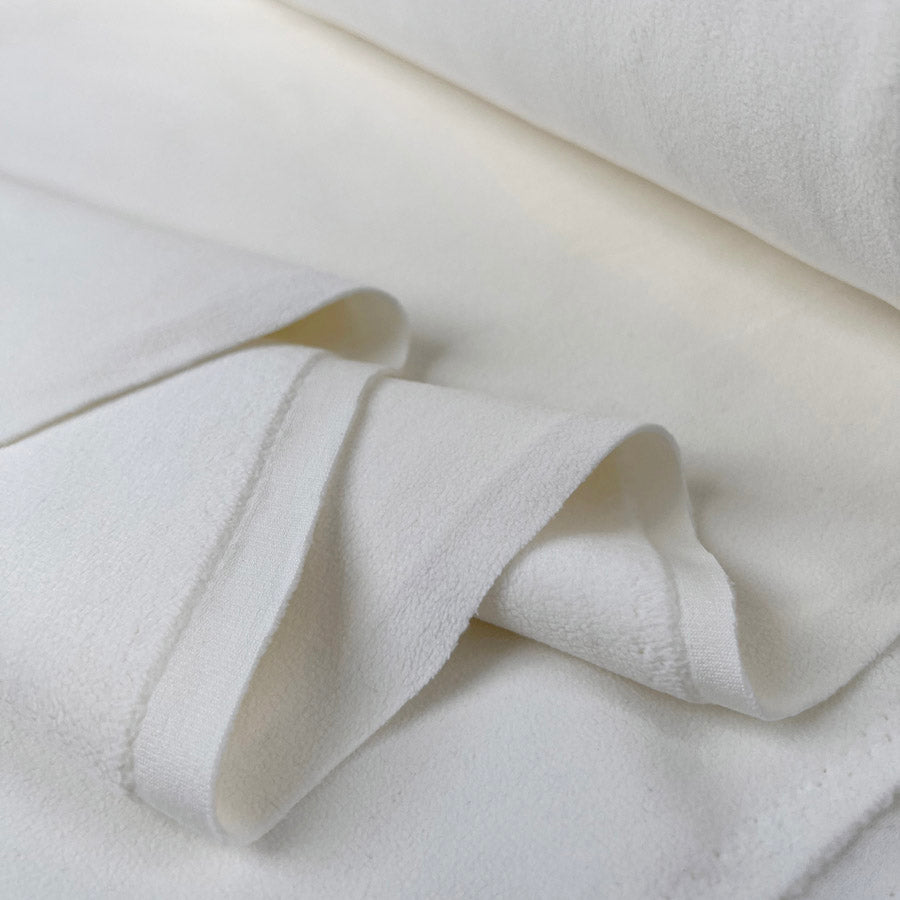Double sided stretch fleece ivory polyester spandex fabric fold