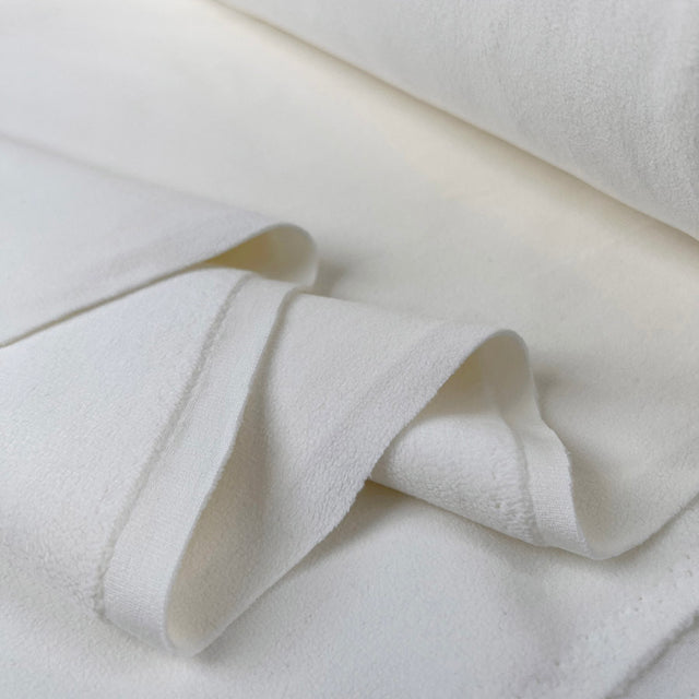 Double sided stretch fleece ivory polyester spandex fabric fold