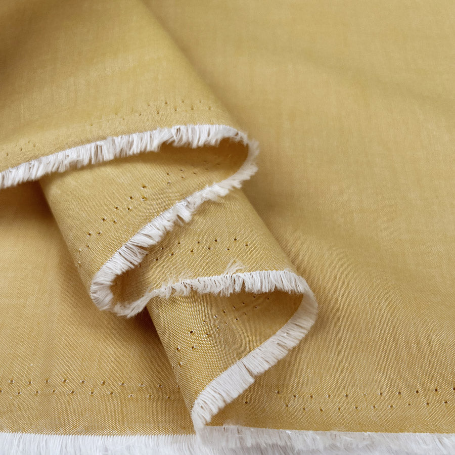 Finest Chambray Ochre Cotton Lightweight Plain Woven Dress Fabric Fold