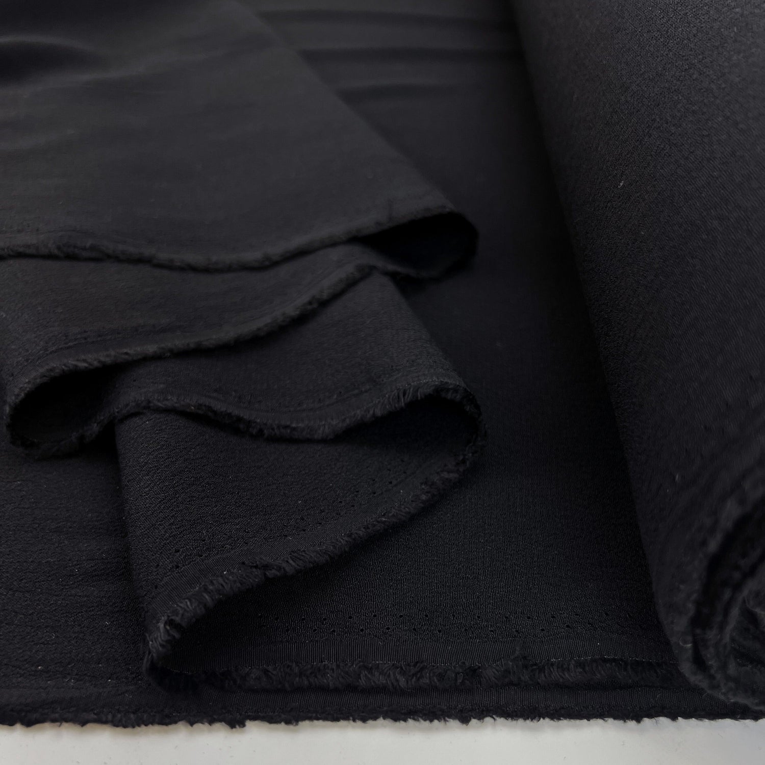 Gardinia Black Plain Lightweight Dressmaking Fabric Viscose Crepe Black Fold