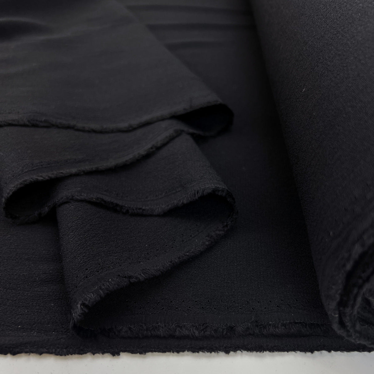 Gardinia Black Plain Lightweight Dressmaking Fabric Viscose Crepe Black Fold