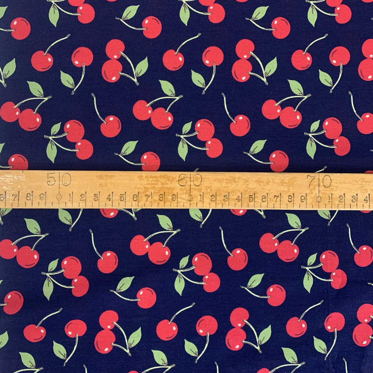 Poplin Print Cherries Navy Cotton With Red Cherries On And Green Leaves Scale