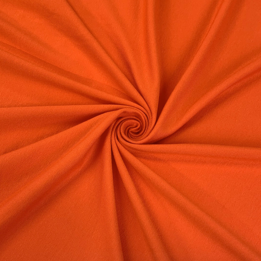 Spongle Orange Knitted Bright Viscose Lycra Jersey Fabric Close Up Draoe Dress Fabric Photo