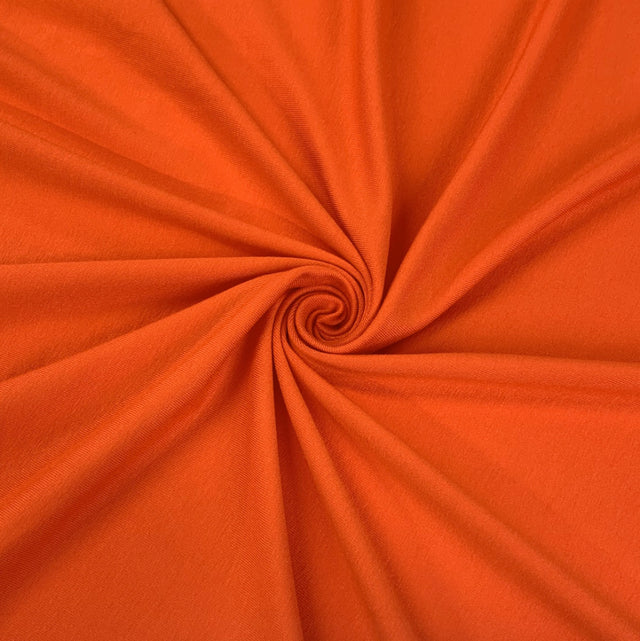 Spongle Orange Knitted Bright Viscose Lycra Jersey Fabric Close Up Draoe Dress Fabric Photo