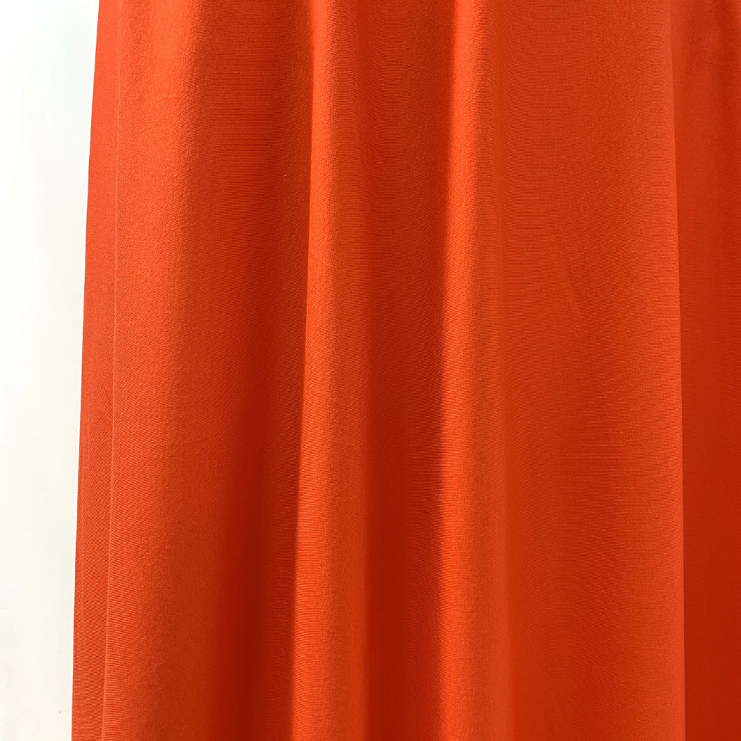 Spongle Orange Knitted Bright Viscose Lycra Jersey Fabric Manequin Close Up Drape Fabric Photo