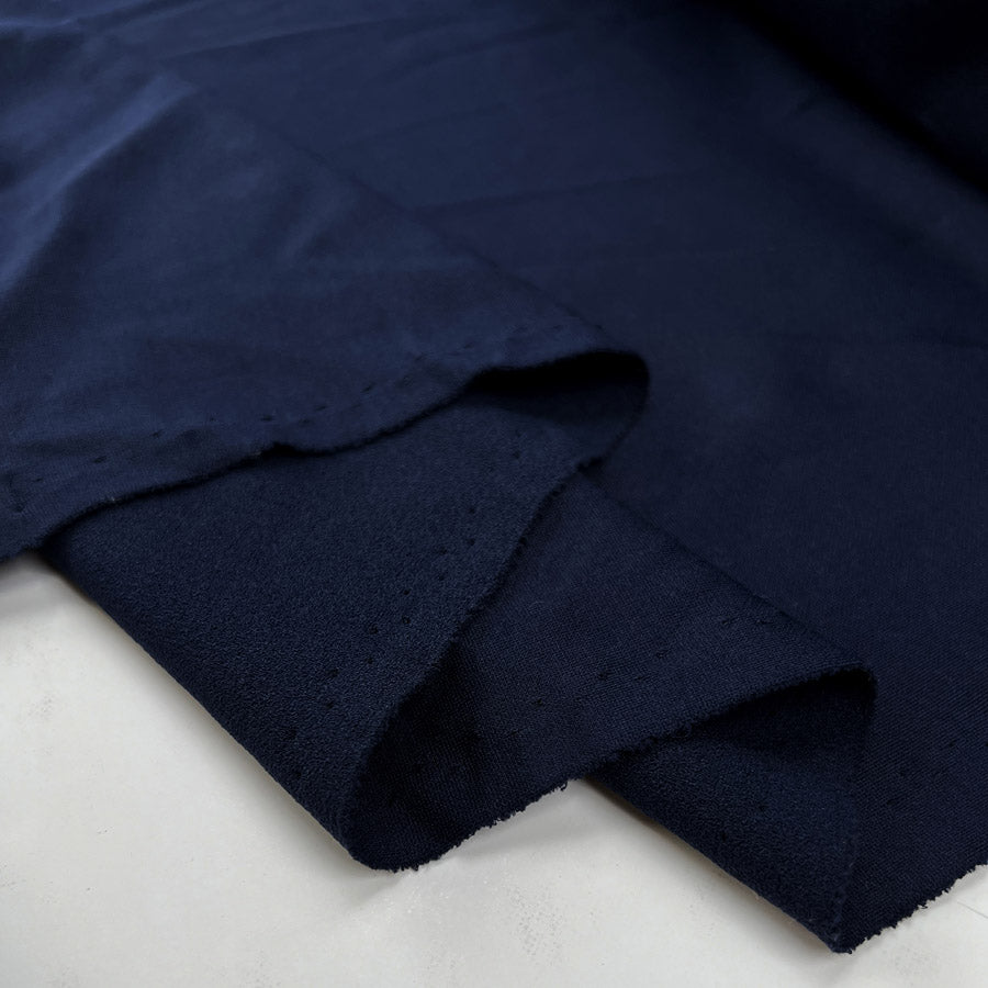 Textured jersey navy polyester knitted dress fabric fold